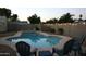 Backyard pool with lounge chairs and festive string lights for evening enjoyment at 932 W Julie Dr, Tempe, AZ 85283