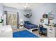 Blue bedroom featuring a desk area, a full bed, a window with shutters, and a ceiling fan at 9901 N 51St Pl, Paradise Valley, AZ 85253