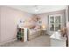 Pink bedroom with a whimsical design, featuring a daybed, bookshelf, and window with shutters at 9901 N 51St Pl, Paradise Valley, AZ 85253