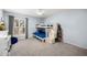 Blue bedroom featuring a bunk bed with storage steps, a window with shutters, and a ceiling fan at 9901 N 51St Pl, Paradise Valley, AZ 85253