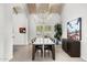 Bright dining room featuring modern light fixture, large window, and views of the living area at 9901 N 51St Pl, Paradise Valley, AZ 85253