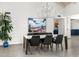 Spacious dining room featuring modern light fixture, large window, and views of the living area at 9901 N 51St Pl, Paradise Valley, AZ 85253