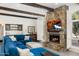 Open concept living room showcasing stone fireplace, wet bar, and beamed ceilings at 9901 N 51St Pl, Paradise Valley, AZ 85253