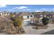 Aerial view of a two-story home with a well-manicured lawn and a driveway at 10146 W Watkins St, Tolleson, AZ 85353