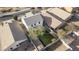 Aerial view of a fenced backyard featuring lush green grass, a mature tree, and privacy at 10146 W Watkins St, Tolleson, AZ 85353