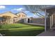 Manicured lawn and block wall fencing viewed from the screened-in patio at 10146 W Watkins St, Tolleson, AZ 85353