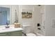 Charming bathroom with classic fixtures, fresh white tiles, and stylish olive green vanity at 10146 W Watkins St, Tolleson, AZ 85353