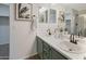 Bathroom featuring a double sink vanity, decorative art, and modern vanity lighting at 10146 W Watkins St, Tolleson, AZ 85353