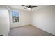 Bedroom with light colored walls, a ceiling fan and a view to the outside at 10146 W Watkins St, Tolleson, AZ 85353