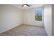 Cozy bedroom featuring carpet, a ceiling fan, and natural light from a window at 10146 W Watkins St, Tolleson, AZ 85353