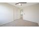 A bedroom featuring neutral carpet and a closet, providing a comfortable and tidy space at 10146 W Watkins St, Tolleson, AZ 85353