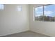 Bright bedroom with large windows providing natural light and views of the outdoors at 10146 W Watkins St, Tolleson, AZ 85353