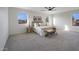 Spacious main bedroom with arched windows, a ceiling fan, and neutral carpet at 10146 W Watkins St, Tolleson, AZ 85353