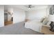 Large main bedroom featuring a ceiling fan and en suite bath with wood look flooring at 10146 W Watkins St, Tolleson, AZ 85353