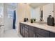 Bathroom featuring double vanity sinks, a large mirror, and a shower-tub combo with curtain at 10209 E Ursula Ave, Mesa, AZ 85212