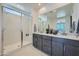 Bright bathroom featuring double vanity sinks, a large mirror, and a glass-enclosed walk-in shower at 10209 E Ursula Ave, Mesa, AZ 85212