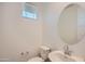 Cozy half bathroom with modern sink, toilet and large round mirror at 10209 E Ursula Ave, Mesa, AZ 85212