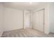 Well-lit bedroom featuring neutral carpet, white walls, and a closet with sliding doors at 10209 E Ursula Ave, Mesa, AZ 85212