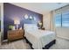 Bedroom with a purple accent wall and carpeted floors at 10209 E Ursula Ave, Mesa, AZ 85212