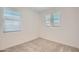 Neutral carpeted bedroom with bright windows and white walls at 10209 E Ursula Ave, Mesa, AZ 85212