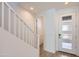 Bright entryway with white banister, neutral-toned flooring, and a modern front door with glass panels at 10209 E Ursula Ave, Mesa, AZ 85212