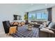 Living room featuring a large sectional sofa, accent chair, contemporary décor, and ample natural light at 10209 E Ursula Ave, Mesa, AZ 85212