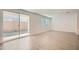 Open living area with light wood-look tile flooring and sliding glass door leading to the backyard at 10209 E Ursula Ave, Mesa, AZ 85212