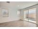 Bright living area with neutral tile flooring, large windows, and a sliding glass door at 10209 E Ursula Ave, Mesa, AZ 85212