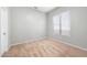 A carpeted bedroom featuring a bright window, neutral walls, base trim and an interior door with a silver handle at 10449 E Lomita Ave, Mesa, AZ 85209