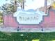 Welcoming entrance sign for The Villages of Eastridge, set amidst lush landscaping and manicured grounds at 10449 E Lomita Ave, Mesa, AZ 85209