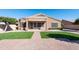 Charming single-story home with well-manicured lawn, brick-paved walkway, and a covered front porch at 10449 E Lomita Ave, Mesa, AZ 85209