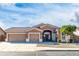 Charming single-story home with a three-car garage and desert landscaping at 10449 E Lomita Ave, Mesa, AZ 85209