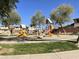 Community playground featuring slides and climbing structures, nestled among mature shade trees and well-maintained lawns at 10449 E Lomita Ave, Mesa, AZ 85209