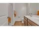 Bright bathroom featuring a shower with orange-themed shower curtain and wood-look flooring at 1052 W Capulin Trl, San Tan Valley, AZ 85140