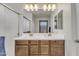 Bright bathroom featuring a double sink vanity with wood cabinets and white countertops at 1052 W Capulin Trl, San Tan Valley, AZ 85140