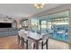 Dining area with large sliding doors opening to a pool and an outdoor living space at 1052 W Capulin Trl, San Tan Valley, AZ 85140