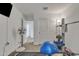 Bright exercise room featuring carpeted flooring, a ceiling fan, and mirrored closet doors at 1052 W Capulin Trl, San Tan Valley, AZ 85140