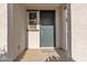 Welcoming front porch featuring a stylish green front door and neutral textured walls at 1052 W Capulin Trl, San Tan Valley, AZ 85140