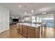 Open concept kitchen with granite island connecting to the living and dining areas at 1052 W Capulin Trl, San Tan Valley, AZ 85140