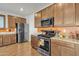 Modern kitchen featuring stainless appliances, granite counters, and custom cabinetry at 1052 W Capulin Trl, San Tan Valley, AZ 85140