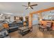 Inviting living room with wood floors, modern furniture, ceiling fan and an open floor plan at 1052 W Capulin Trl, San Tan Valley, AZ 85140