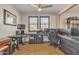 Spacious office with ceiling fan and dark wood flooring, and a dark L-shaped desk at 1052 W Capulin Trl, San Tan Valley, AZ 85140