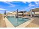 Full view of the sparkling pool and outdoor living area with pergola, seating and waterfall feature at 1052 W Capulin Trl, San Tan Valley, AZ 85140