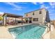 Backyard view of the sparkling pool and patio area with outdoor seating and pergola at 1052 W Capulin Trl, San Tan Valley, AZ 85140