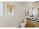 Powder room with a patterned cabinet and framed art at 10540 N 78Th Pl, Scottsdale, AZ 85258