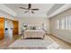 Bright bedroom featuring ceiling fan, ensuite bath, and natural light at 10540 N 78Th Pl, Scottsdale, AZ 85258