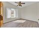 Bright bedroom features a ceiling fan, light walls, wood-look flooring, and a window with plantation shutters at 10540 N 78Th Pl, Scottsdale, AZ 85258