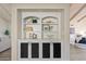 Stylish built-in featuring modern black doors and decorative shelving, adding functional elegance to the home at 10540 N 78Th Pl, Scottsdale, AZ 85258