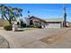 A charming home with desert landscaping, a terracotta tile roof, and an attached two-car garage at 10540 N 78Th Pl, Scottsdale, AZ 85258