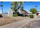 Charming single-story home featuring a terracotta tile roof, desert landscaping, and an arched window at 10540 N 78Th Pl, Scottsdale, AZ 85258